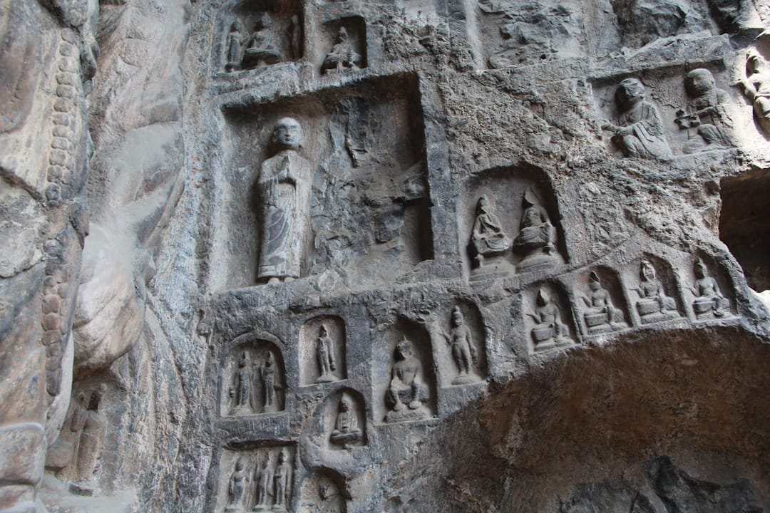 Ancient stone carvings of buddha statues in a cave