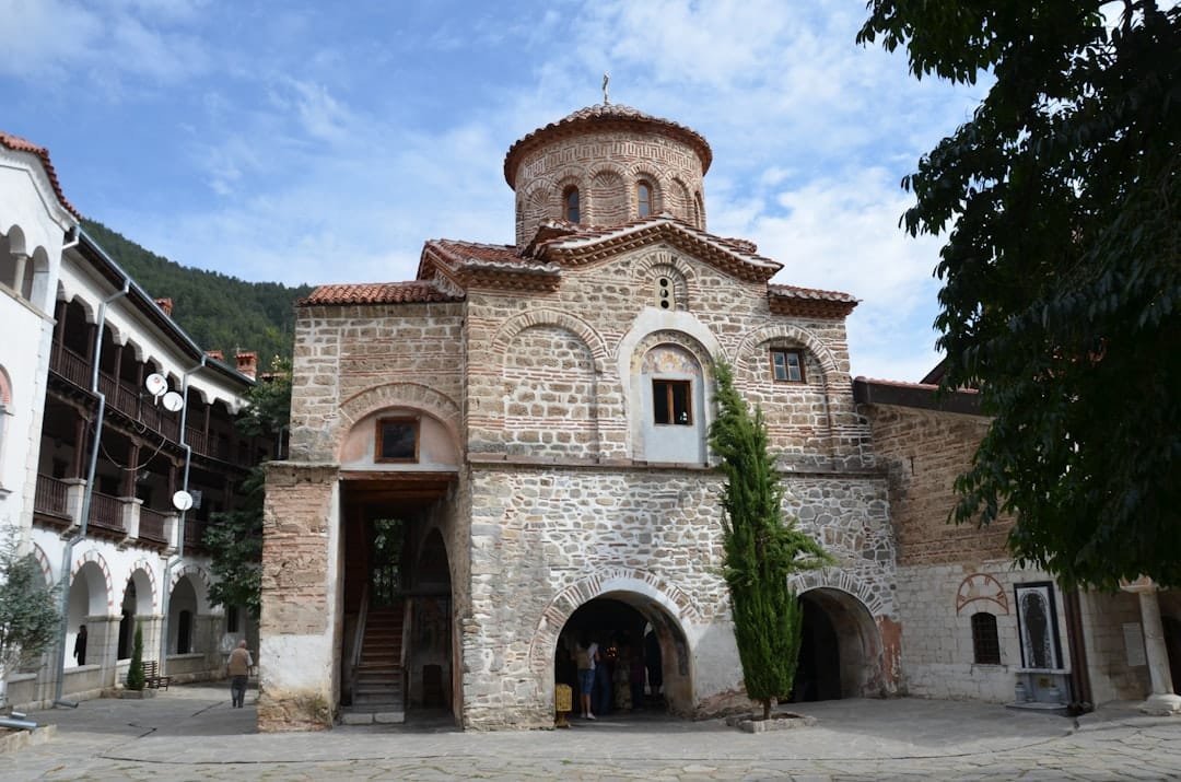 a stone building with a domed roof with Kotor Cathedral in the background