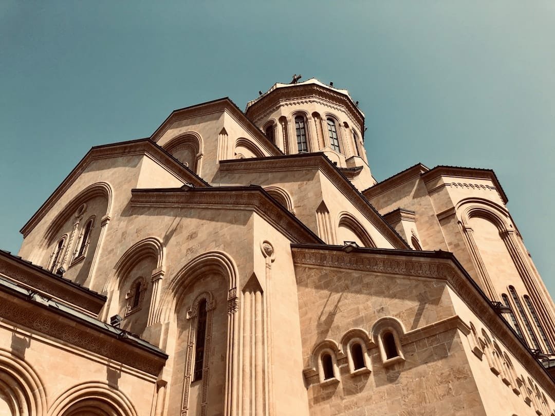 brown and white concrete building under blue sky during daytime